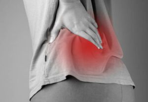 chronic back pain in grayscale with red higlight