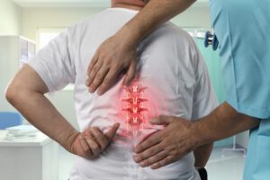 Mature Backache Exam by spine doctor