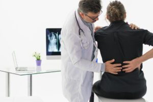 Back Pain Doctor diagnosing the cause of Back Pain